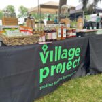 Village Project table at BAYarts Thursday Market