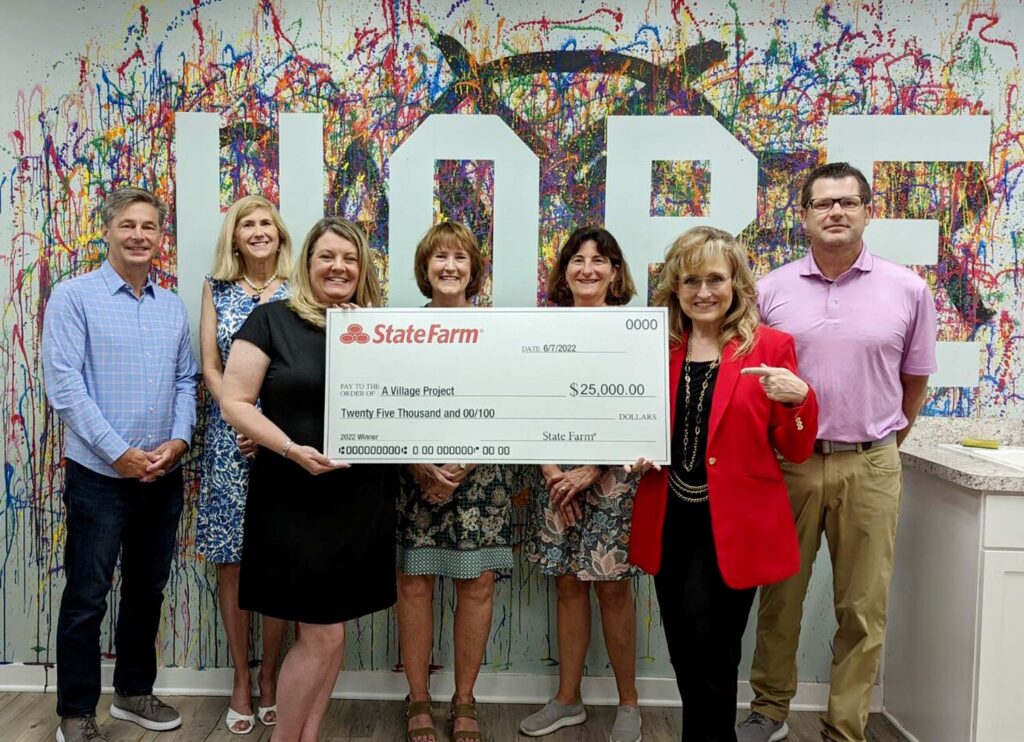 Village Project receives donation check from State Farm